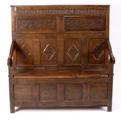 Appraisal: A Jacobean oak settle the panel back with later carved