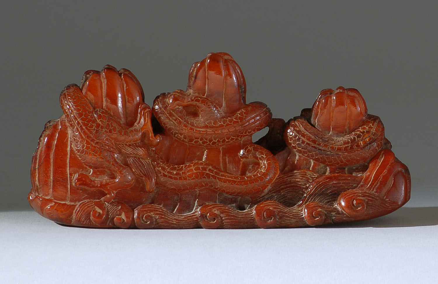 Appraisal: AMBER CARVING th CenturyDesigned as a wrist rest with two