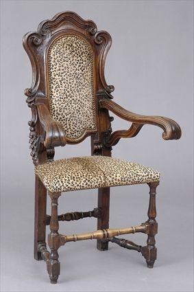 Appraisal: ITALIAN ROCOCO-STYLE CARVED WALNUT OPEN ARMCHAIR The cartouche-shape back within