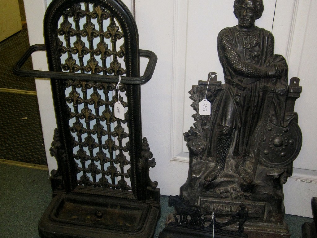 Appraisal: Lot comprising cast iron stickstand and two door stops one