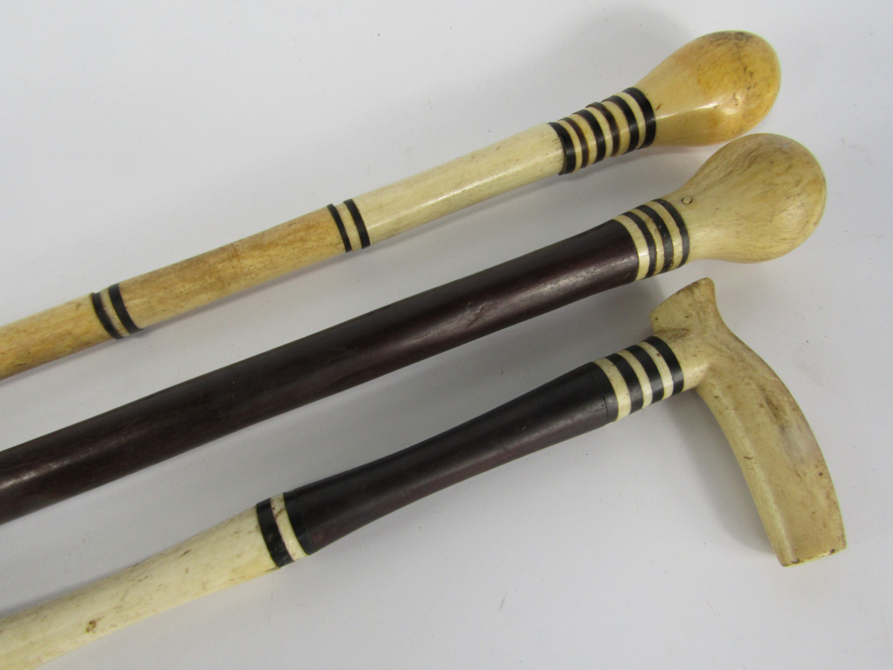 Appraisal: Three Victorian marine ivory and ebony walking sticks with banded