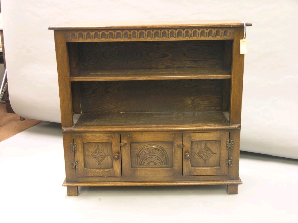 Appraisal: A solid medium oak open bookcase frieze with gouged carving