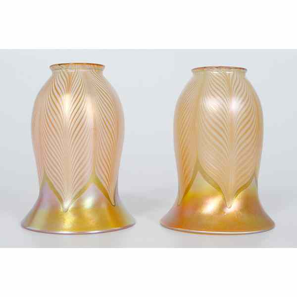 Appraisal: Quezal Pull Feather Glass Shades American a pair of gold