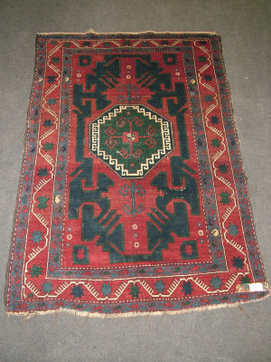 Appraisal: A Kazak rug with octagonal medallion in a deep red