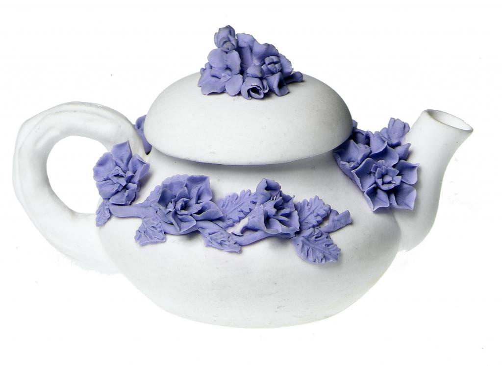 Appraisal: A DERBY BISCUIT MINIATURE TEAPOT AND COVER encrusted with lavender