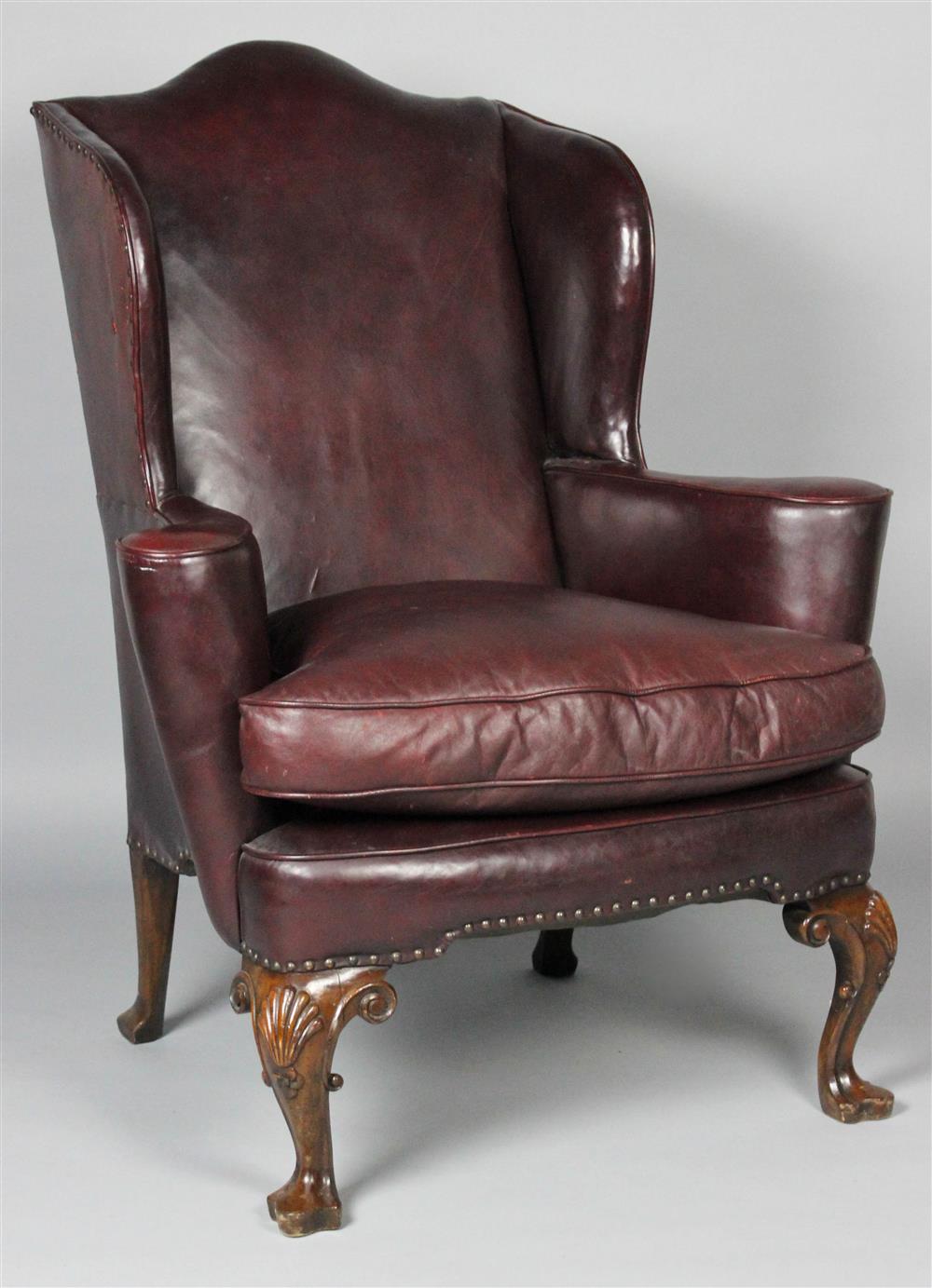 Appraisal: BURGUNDY LEATHER WING CHAIR WITH NAILHEAD TRIM shaped back above