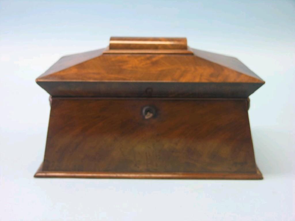 Appraisal: An early Victorian mahogany flame-veneered tea caddy sarcophagus-shape with twin