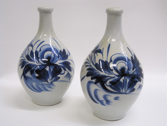 Appraisal: PAIR JAPANESE GLAZED POTTERY SAKE JUGS hand painted blue decoration