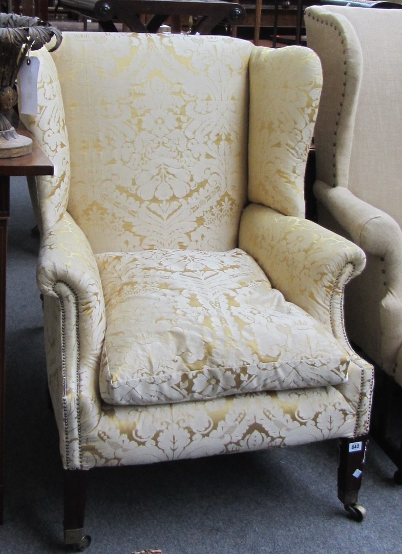 Appraisal: A George III mahogany framed wingback armchair on tapering square