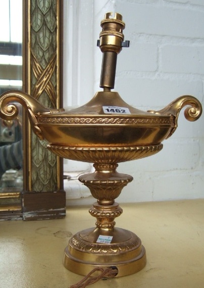 Appraisal: A gilt brass lamp base th century of two handled