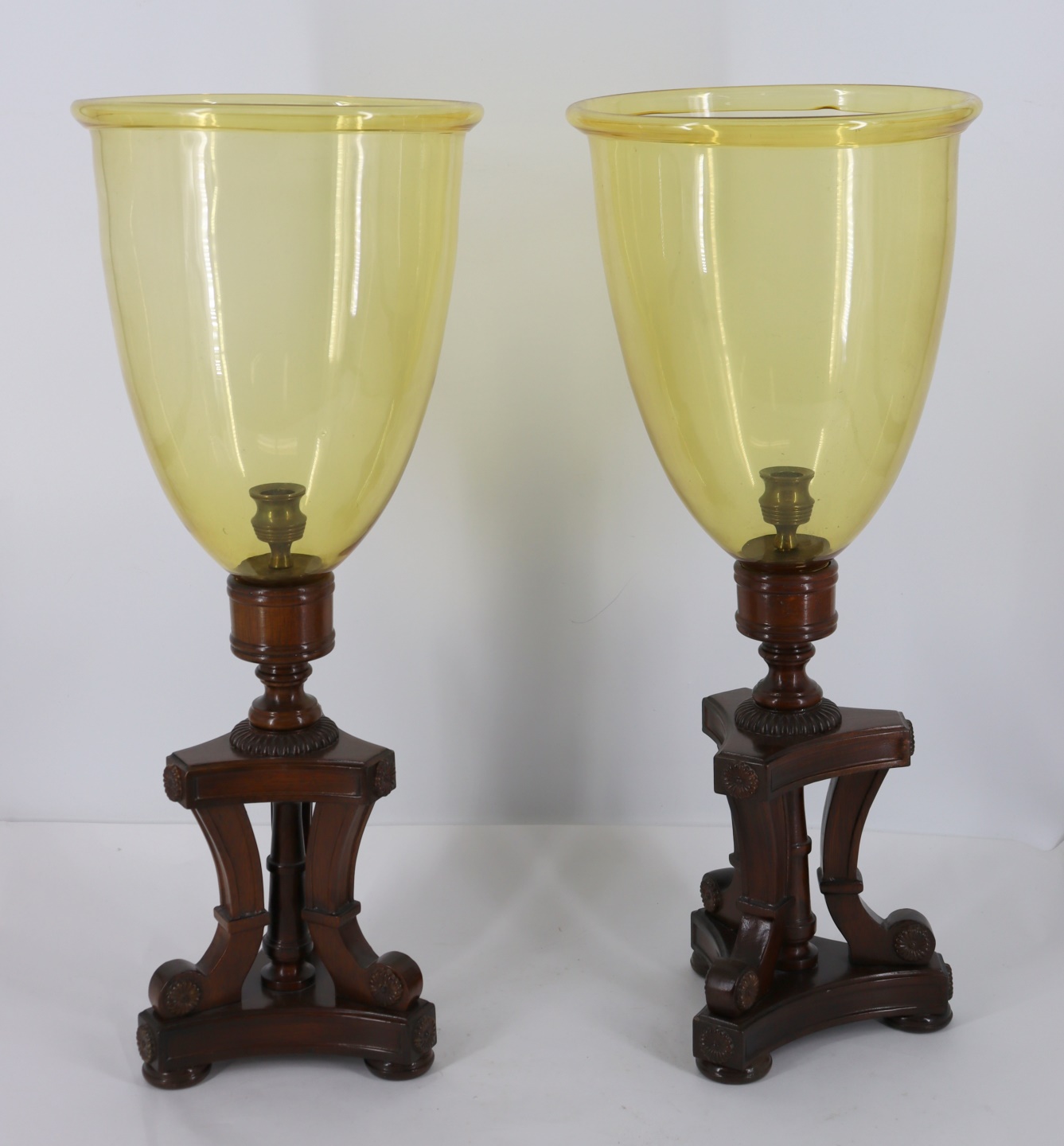 Appraisal: A VINTAGE PAIR OF HURRICANE CANDLE HOLDERS Nice mahogany bases