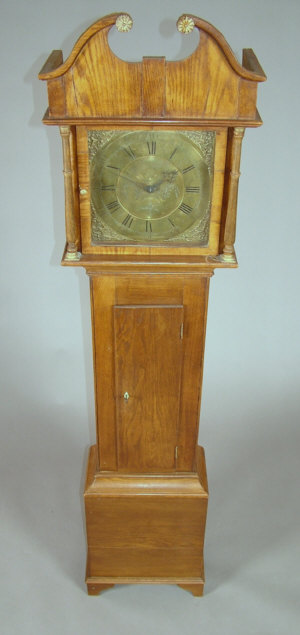 Appraisal: An oak longcase clock the swan neck hood the columns