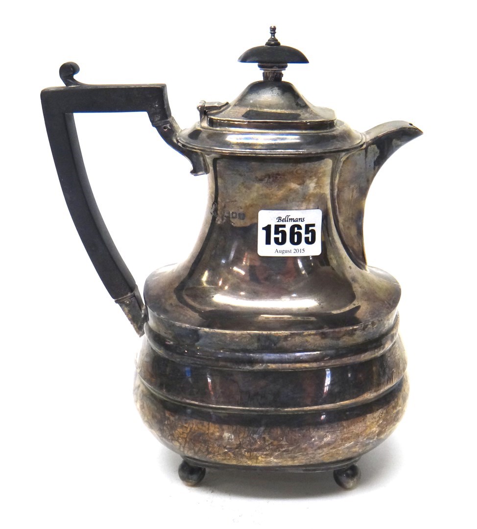 Appraisal: A silver hot water jug of shaped form raised on