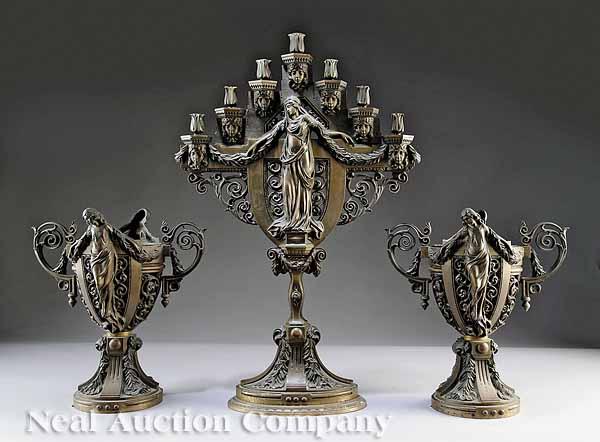 Appraisal: An Antique Renaissance-Style Bronze Garniture c the seven-light candelabrum cast