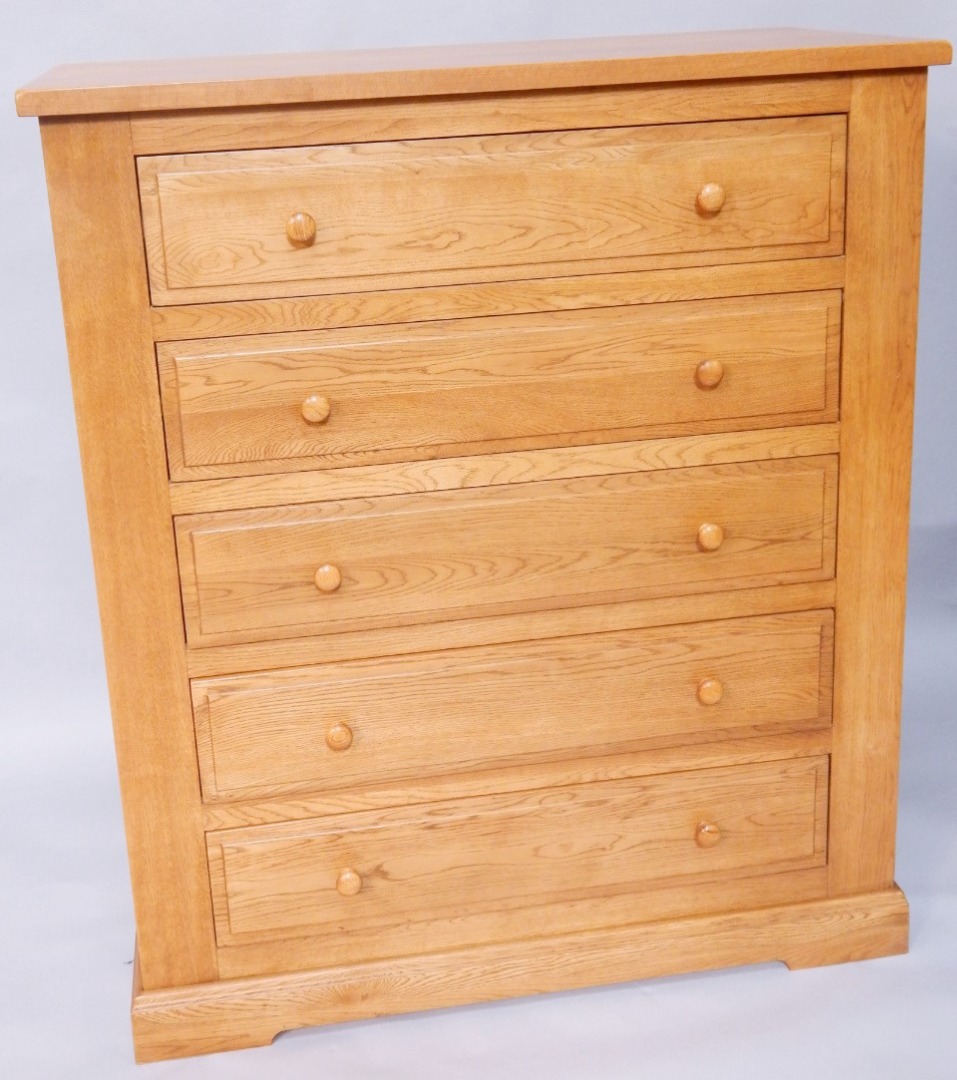 Appraisal: A light oak chest of five long drawers width cm