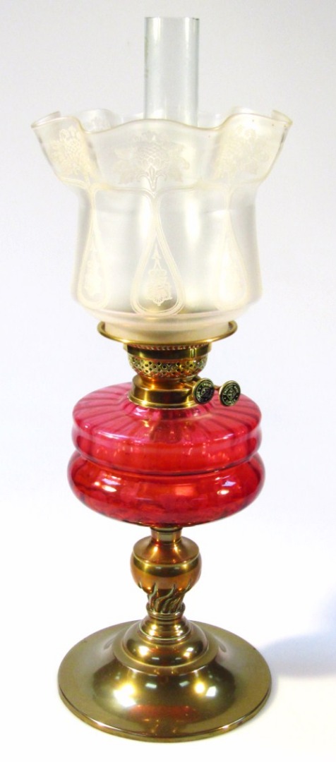 Appraisal: A Victorian oil lamp with clear glass funnel and frosted