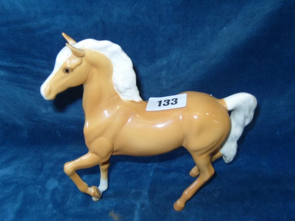 Appraisal: A Beswick model of a Palomino pony with raised foreleg