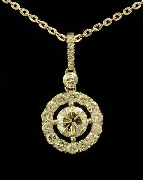 Appraisal: A modern platinum and all diamond set halo pattern pendant