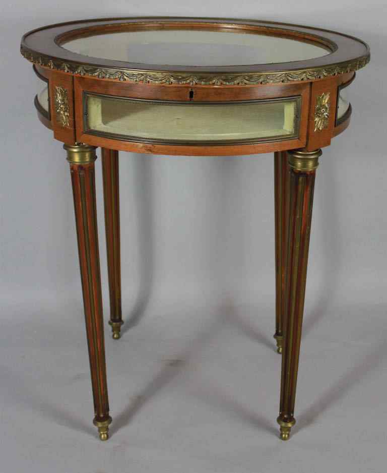 Appraisal: LOUIS XVI STYLE MAHOGANY VITRINE TABLE the circular hinged top