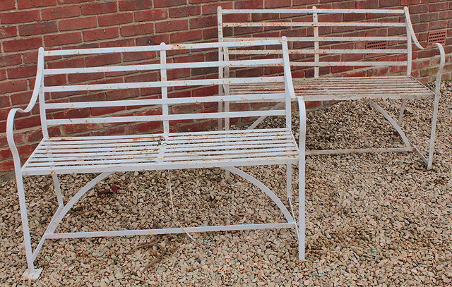 Appraisal: A PAIR OF WHITE PAINTED STRAPWORK GARDEN SEATS with scroll