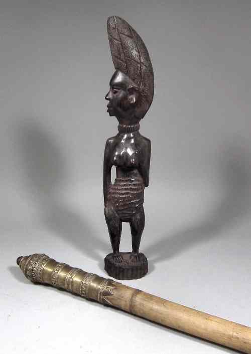 Appraisal: A Nigerian carved hardwood figure of a standing female with