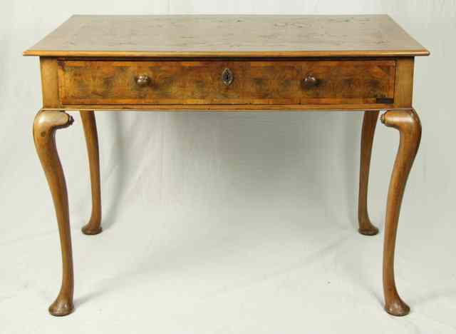 Appraisal: A walnut table with crossbanded top fitted a drawer to