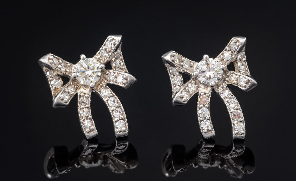 Appraisal: K DIAMOND RIBBON ''BOW'' EARRINGS At the center of the