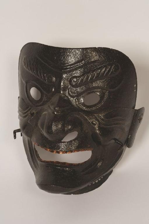 Appraisal: A JAPANESE IRON MASK SOMEN with pierced apertures for the