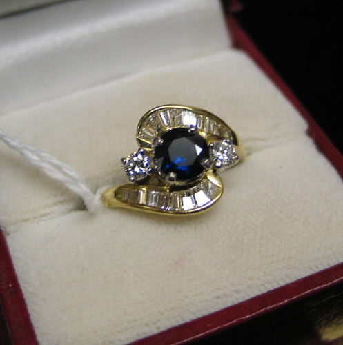 Appraisal: SAPPHIRE DIAMOND EIGHTEEN KARAT GOLD AND PLATINUM RING centering a