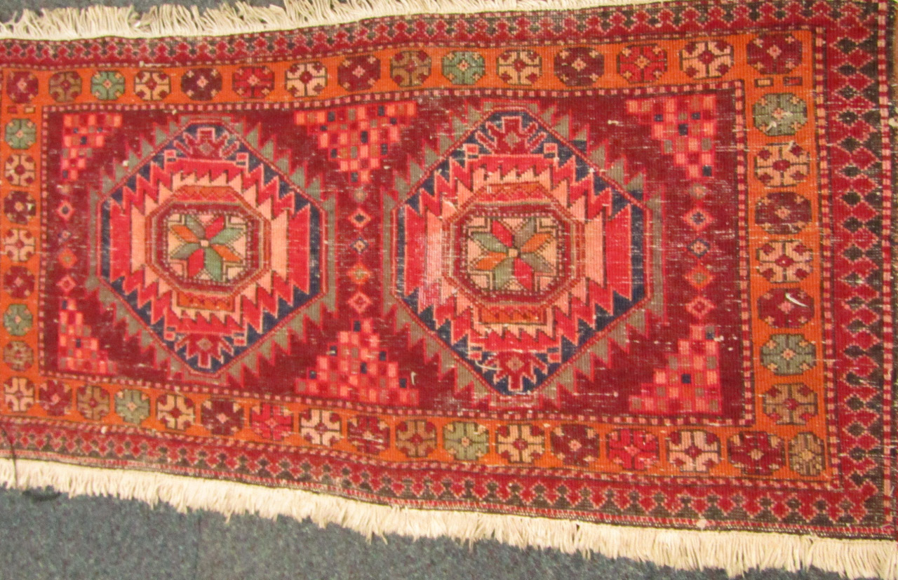 Appraisal: A Caucasian rug decorated with geometric motifs against a red