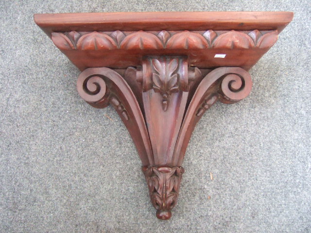 Appraisal: A mahogany wall bracket shelf with carved acanthus leaf decoration