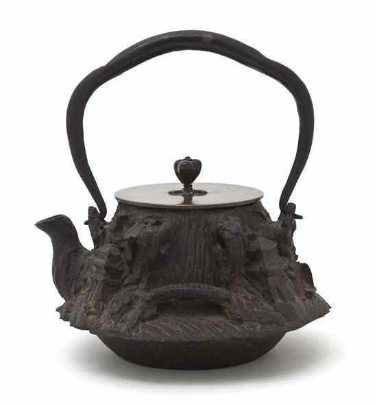 Appraisal: A Japanese Iron and Bronze Teapot of naturalistic form throughout