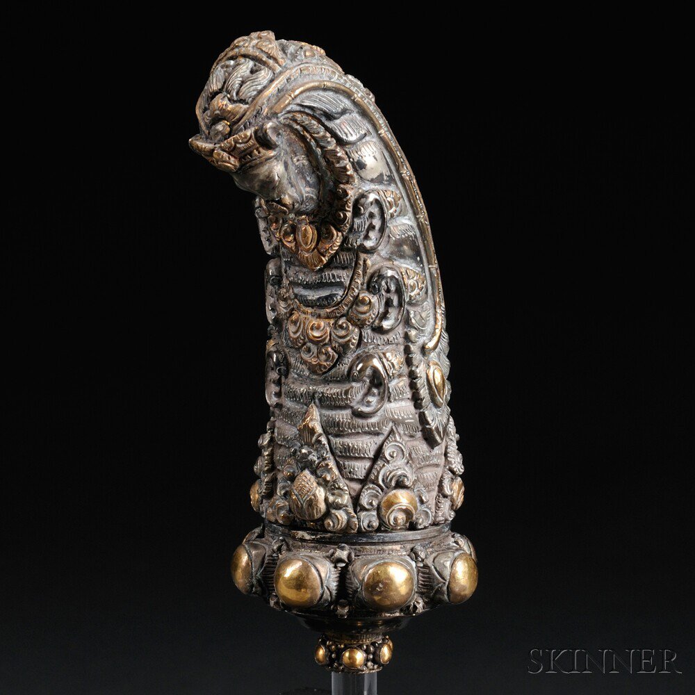 Appraisal: Silvered and Gilt Repousse Kris Hilt Indonesia in the form