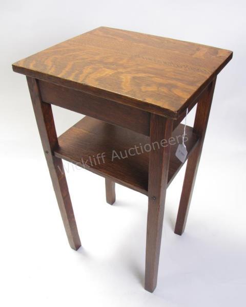 Appraisal: An antique oak stand table with mid shelf square leg