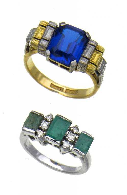 Appraisal: A BLUE STONE RING the step-cut stone between conforming two-colour