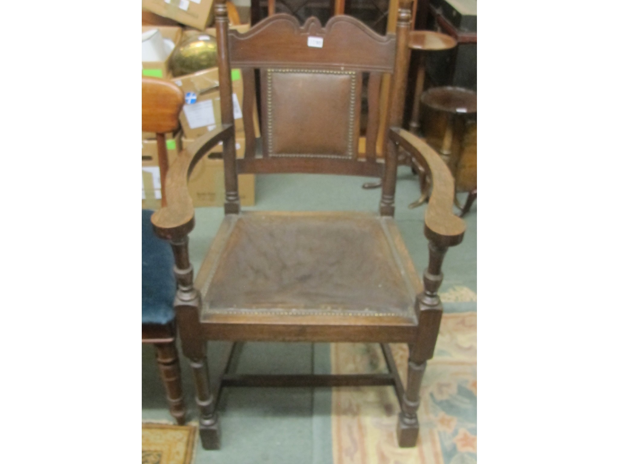 Appraisal: An Edwardian oak armchair with rexine seat