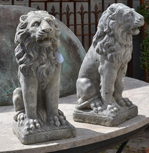 Appraisal: A SMALL PAIR OF COMPOSITE LION FIGURES each modelled seated