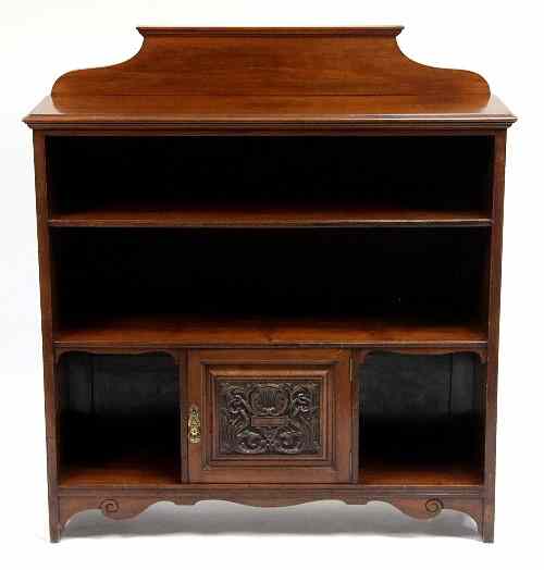 Appraisal: A walnut open bookcase with shaped backboard and covered with