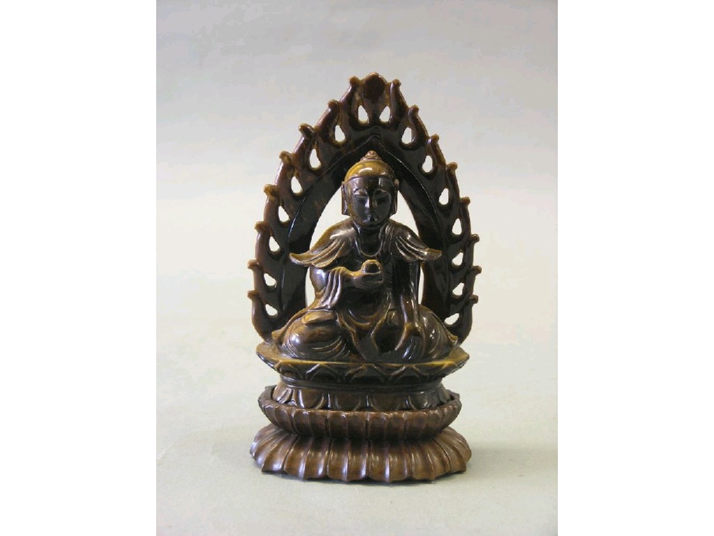 Appraisal: A Chinese 'Tiger's Eye' Buddha seated figure within flame-design surround