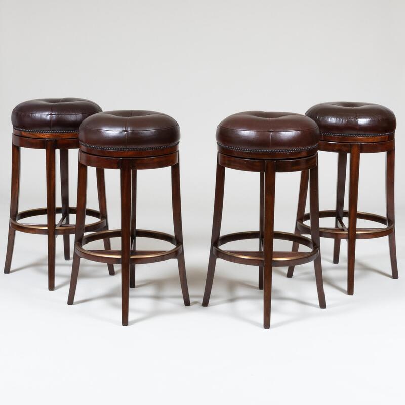 Appraisal: Four Theodore Alexander Stained Wood Leather Upholstered Swivel Bar Stools