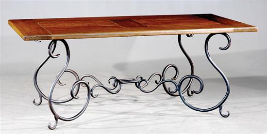 Appraisal: Walnut and cast-iron table rectangular frame-and-panel top on scrolling base