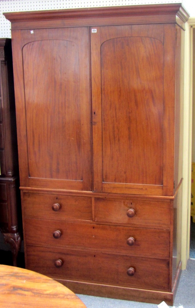 Appraisal: An early Victorian mahogany linen press the arch panel doors