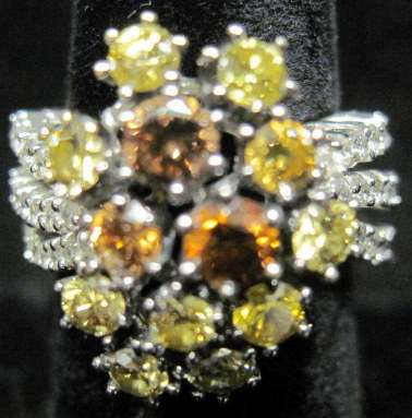 Appraisal: karat white gold diamond cluster ring Thirteen yellow and colored