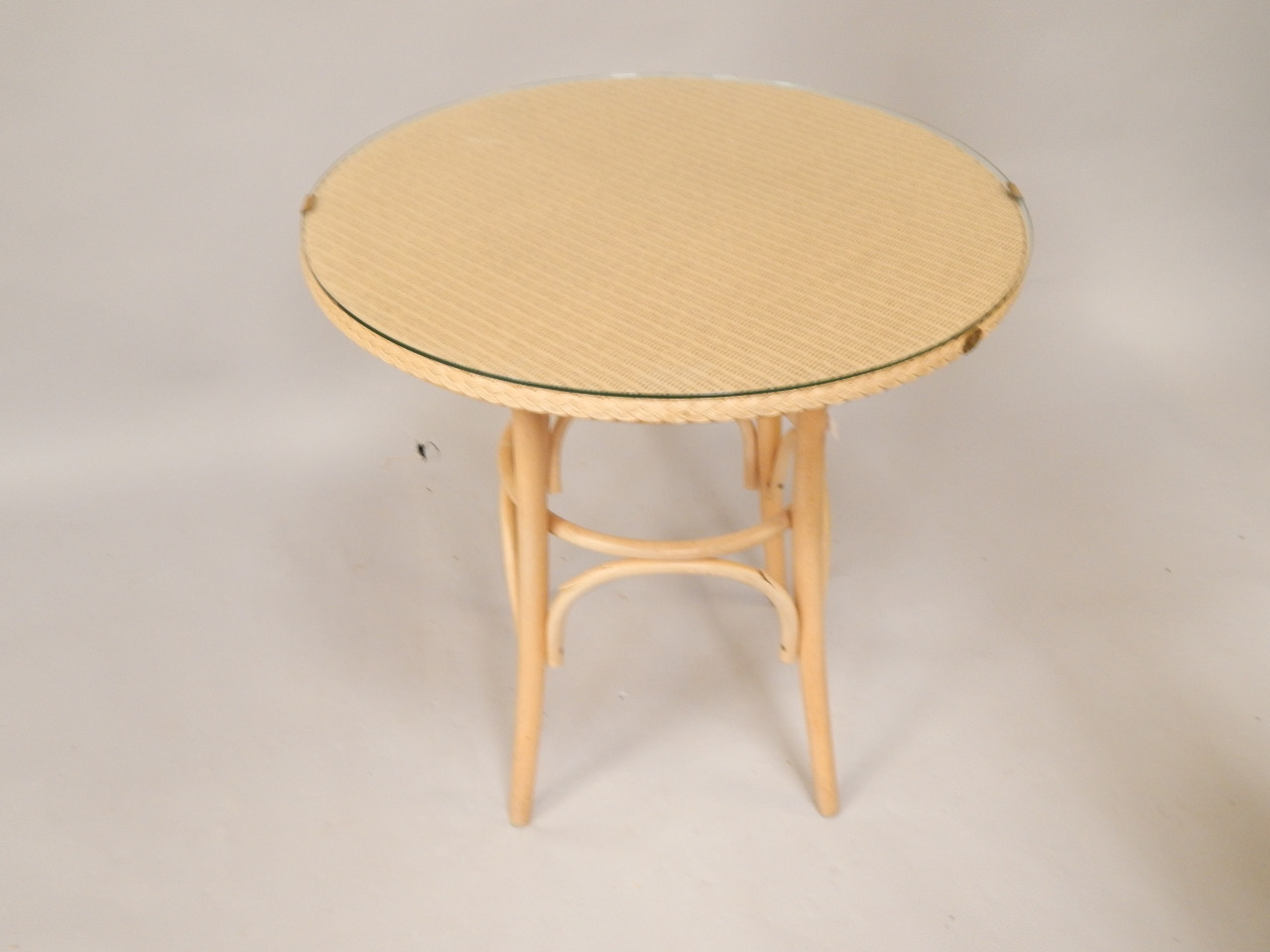 Appraisal: A Lloyd Loom circular table with plate glass top cm