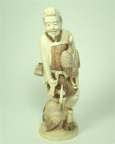 Appraisal: A large Japanese ivory figure of a man with two