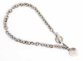 Appraisal: A sterling silver necklace with toggle clasp and heart pendant