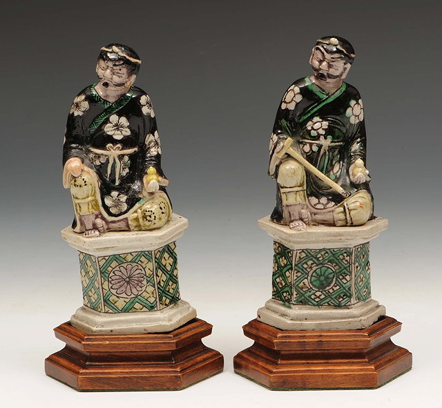 Appraisal: A pair of Chinese biscuit porcelain figuresKangxi - decorated in