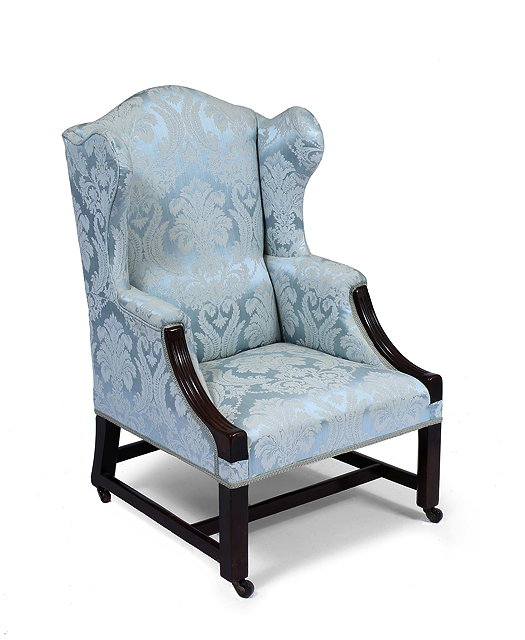 Appraisal: A MAHOGANY FRAMED GEORGIAN STYLE WING BACK ARMCHAIR upholstered in