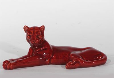 Appraisal: A Minton pottery flambe model of a lioness modelled lying