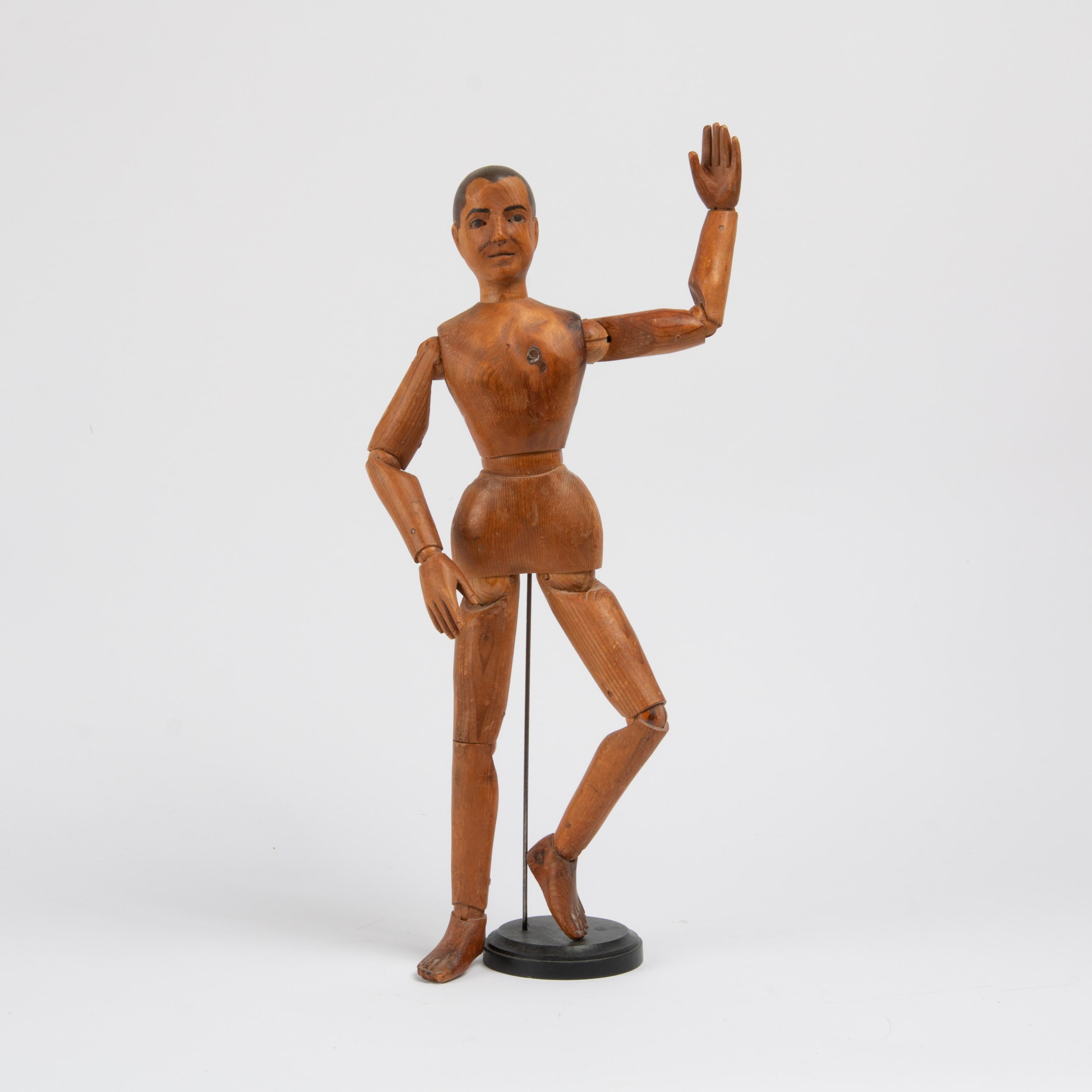 Appraisal: HAND-CARVED ARTICULATED ARTIST'S MODEL A hand-carved fully-articulated wooden mannequin with